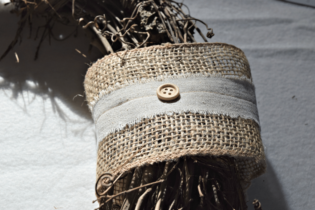 Using burlap ribbon adds the perfect touch to this rustic front door wreath