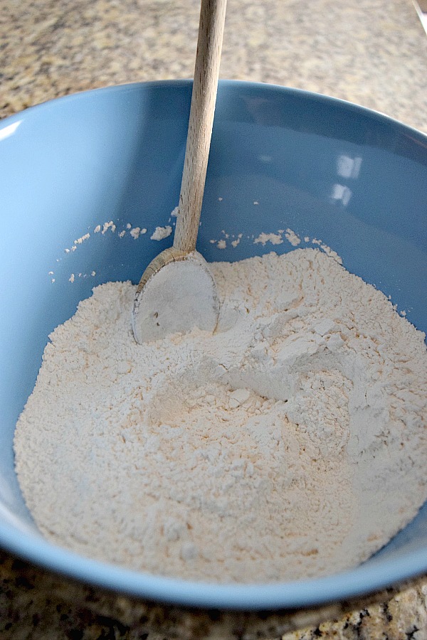 This easy sugar cookie recipe starts with basic flour and other dry ingredients in a mixing bowl