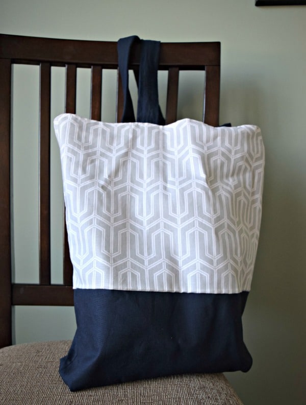 A diy canvas tote bag made with navy blue fabric and a grey and white printed fabric