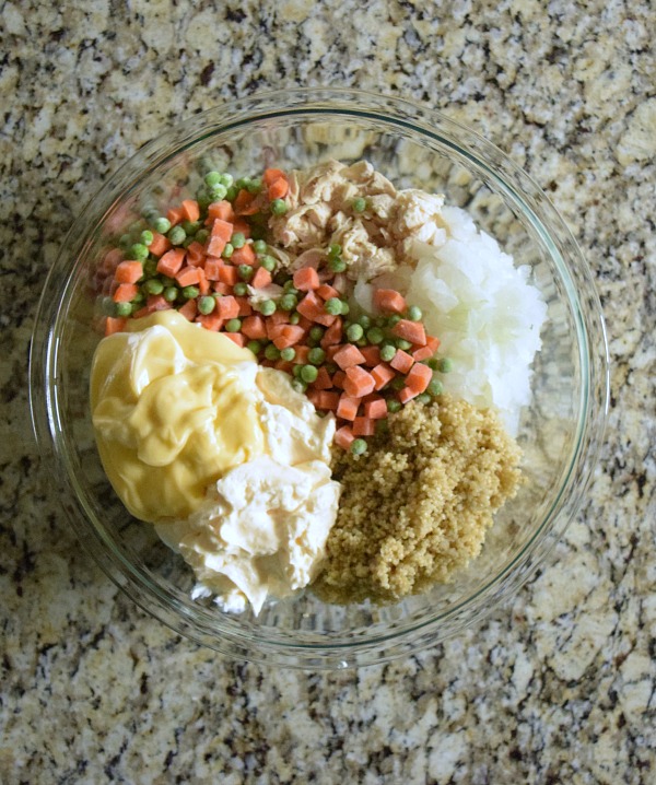 Mix the casserole ingredients together in a large glass bowl. You'll need fresh or frozen carrots and peas, onions, quinoa, and chicken