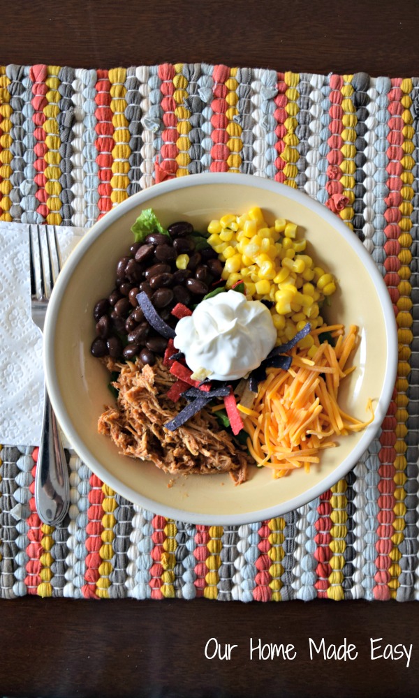 Tender chicken, beans, corn, cheese and sour cream in a bowl