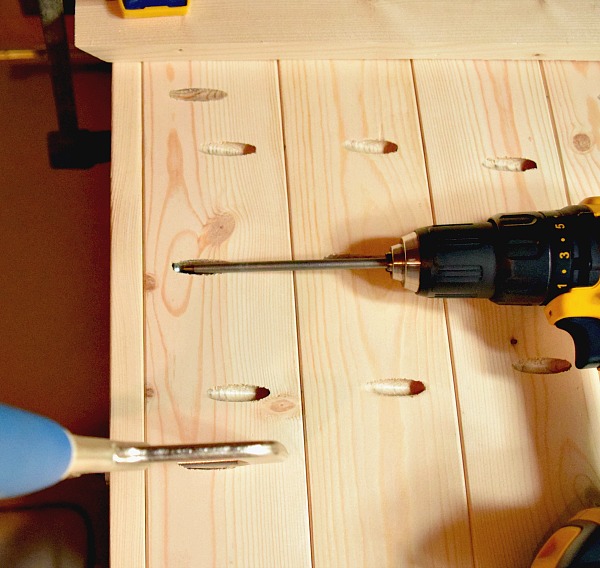 Drilling screws into the wood boards for your DIY wood serving tray