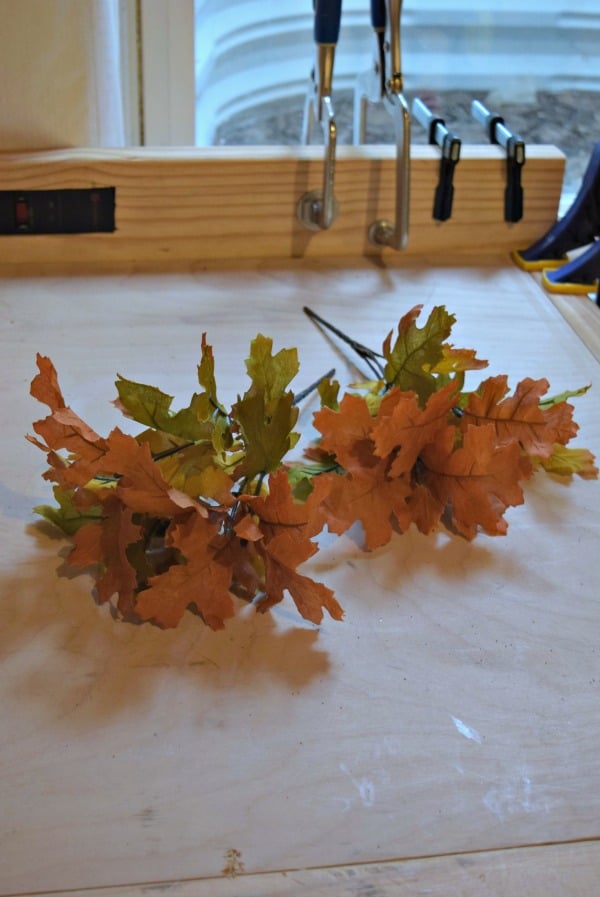 Using fall leaf arrangements from the dollar store is a perfect addition to any fall centerpiece