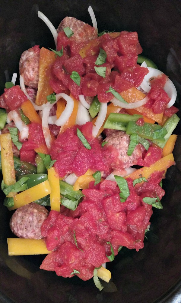 Add meatballs, peppers, and tomato sauce to the slow cooker 