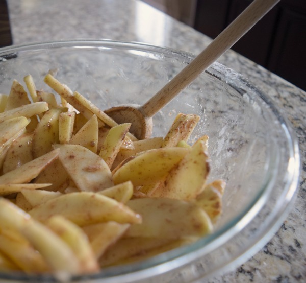Coat the apple slices in sugar and cinnamon