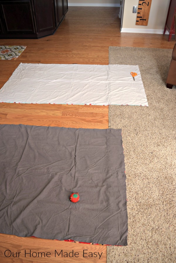 Lay out the flannel fabric on the floor (or other surface with enough space) to trim and cut the fabric to the correct lengths