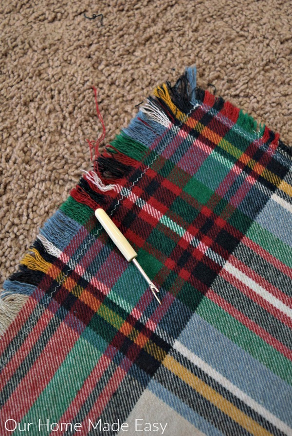 An easy how-to in making your own $5 flannel blanket scarf! Click to see how easy it is to make!