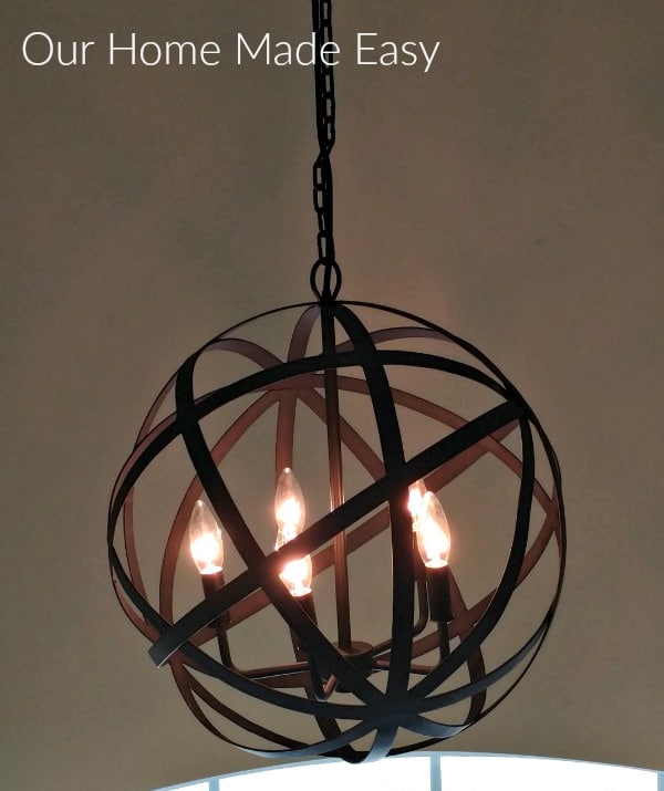 This farmhouse style foyer chandelier is a metal orb with rich lighting that looks great in our home