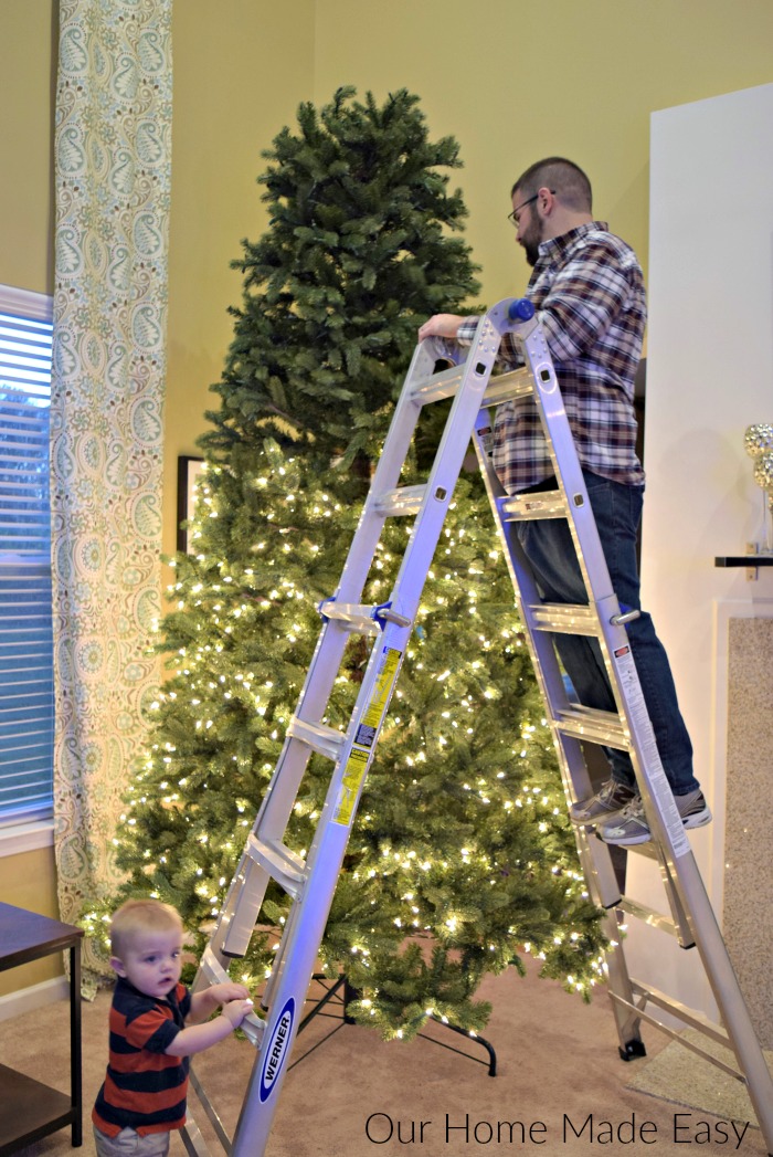 The hubby helping us put together our 12-foot Christmas tree with lights