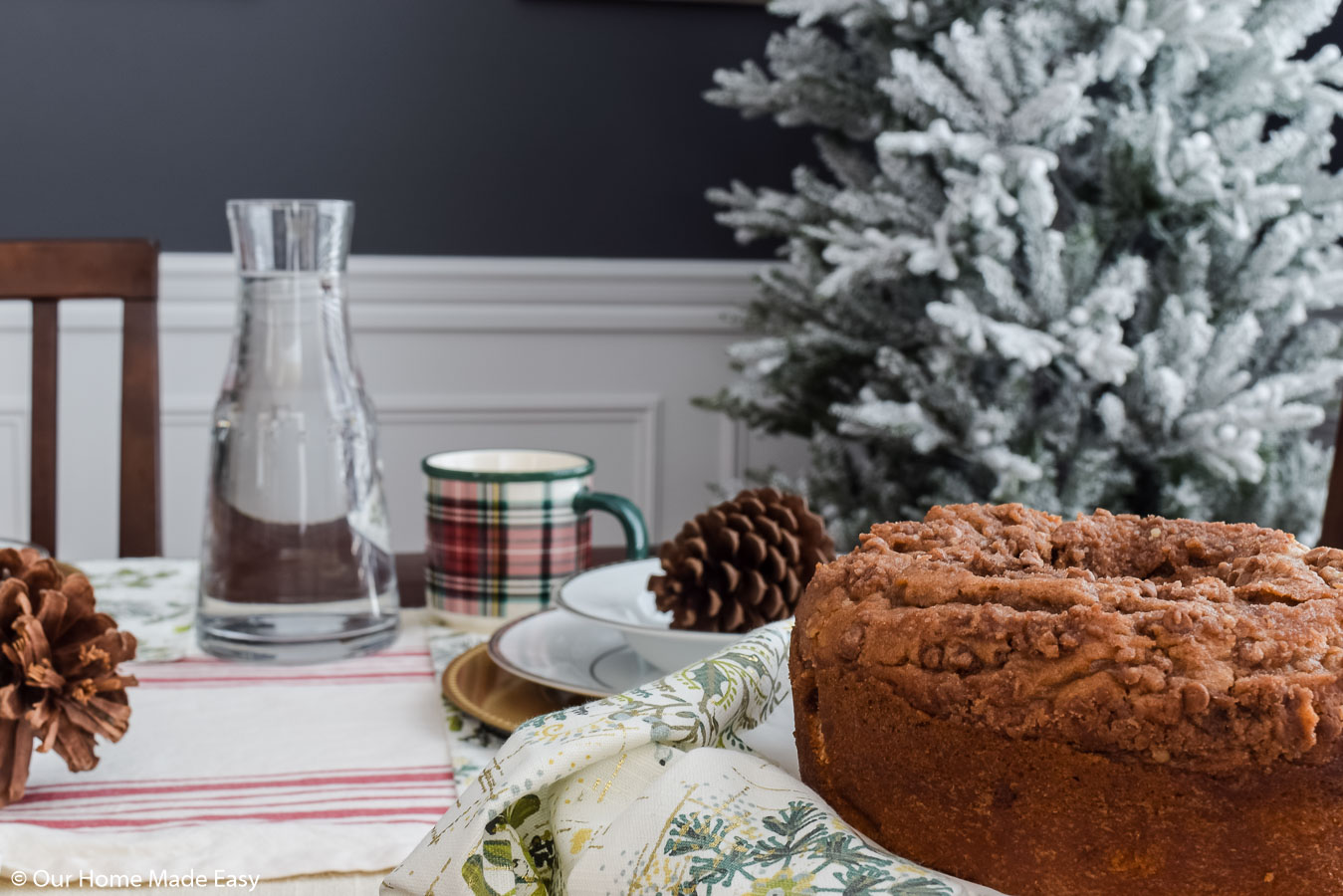 A dining room table set for Christmas morning breakfast with an coffee crumb cake