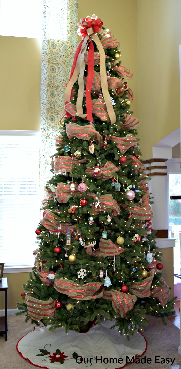 Topped with a flowing bow and ribbons, our Christmas tree is ready to shine!