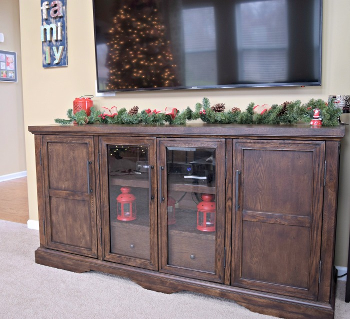 A simple pine garland and some Christmas ornaments was an easy way to decorate our media console