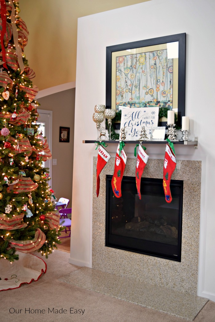 Our makeshift mantel is a simple Ikea shelf donned with candlesticks and our family stockings