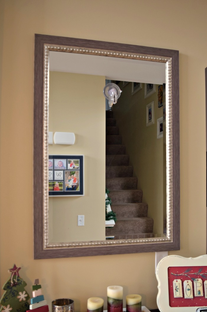 I decided to hang my Pinterest inspired Christmas wreath above a large mirror in our home's hallway