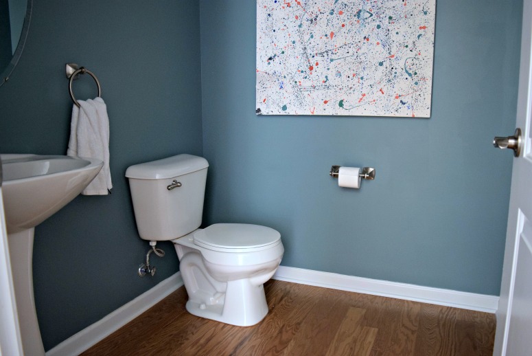 Our first floor powder room is painted a dark teal, making the room even darker without natural light