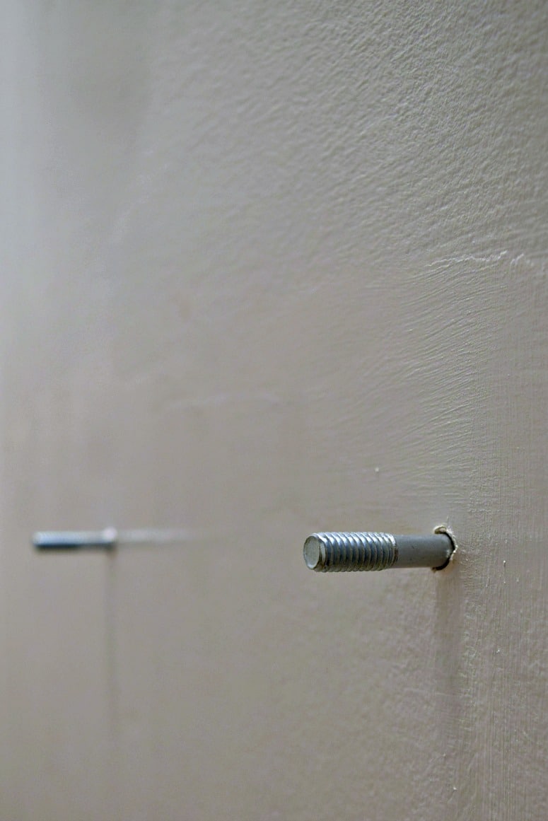 These screws serve as mounting holes for the new pedestal sink