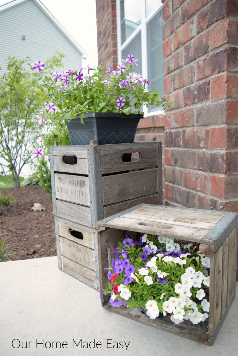 I love using these vintage crates to hold potted plants on our front porch