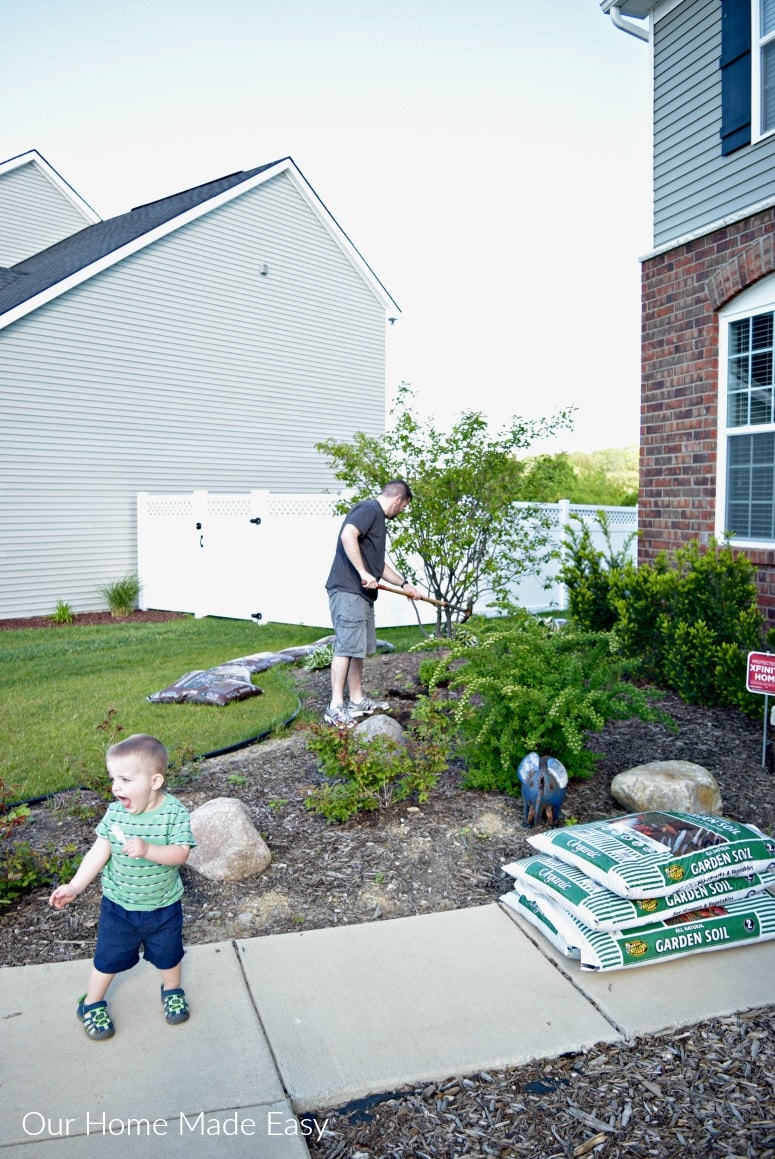 Husband and son working on our summer flower beds on a sunny Michigan weekend