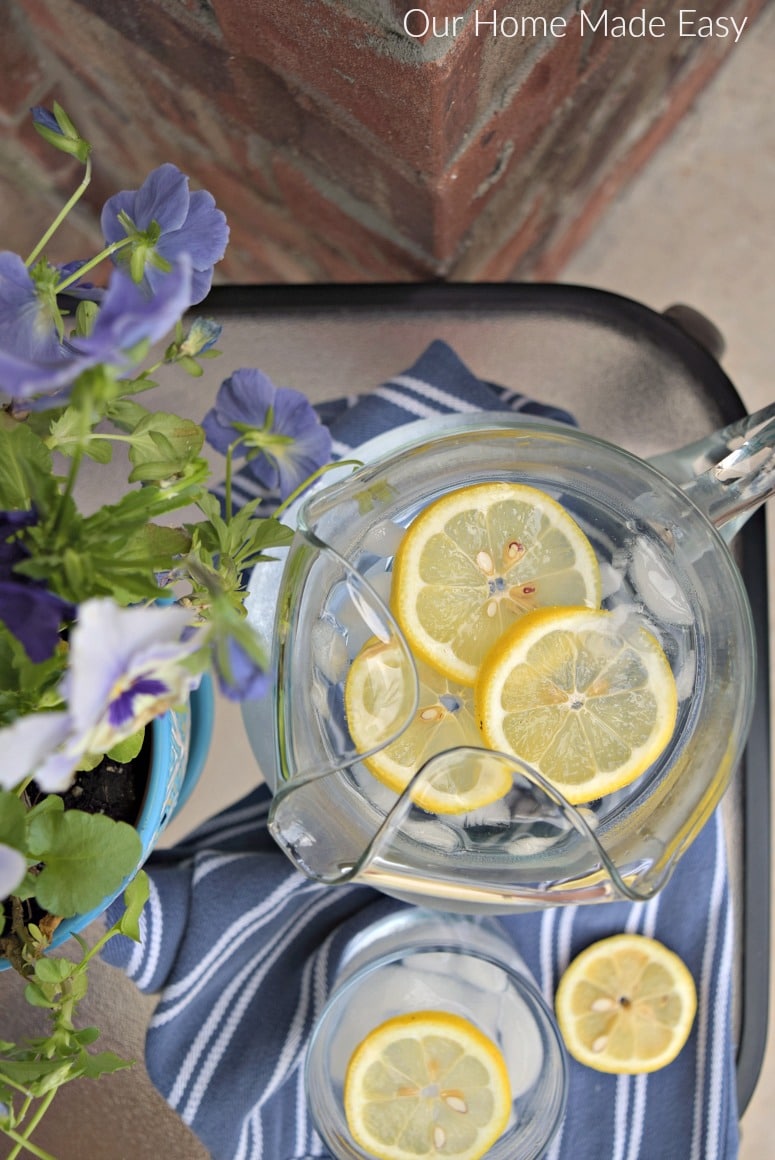 Ice cold lemon water in a glass pitcher is a refreshing summer beverage