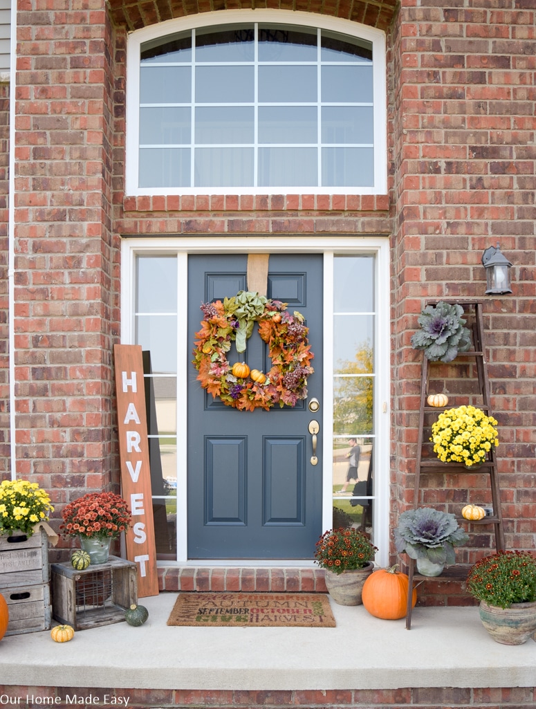 This fully decorated fall front porch is ready to transition into Christmas decor
