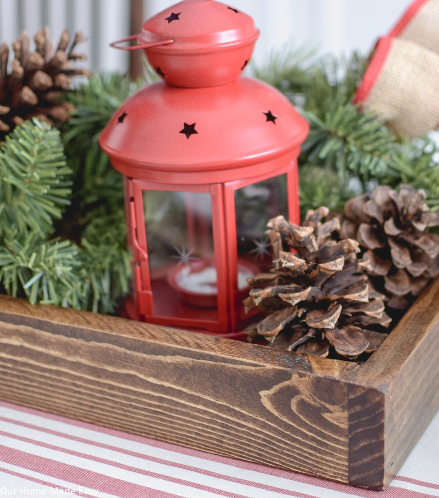 We used this wood serving tray as a Christmas centerpiece, filling it with a lantern, pine cones, and pine tree branches