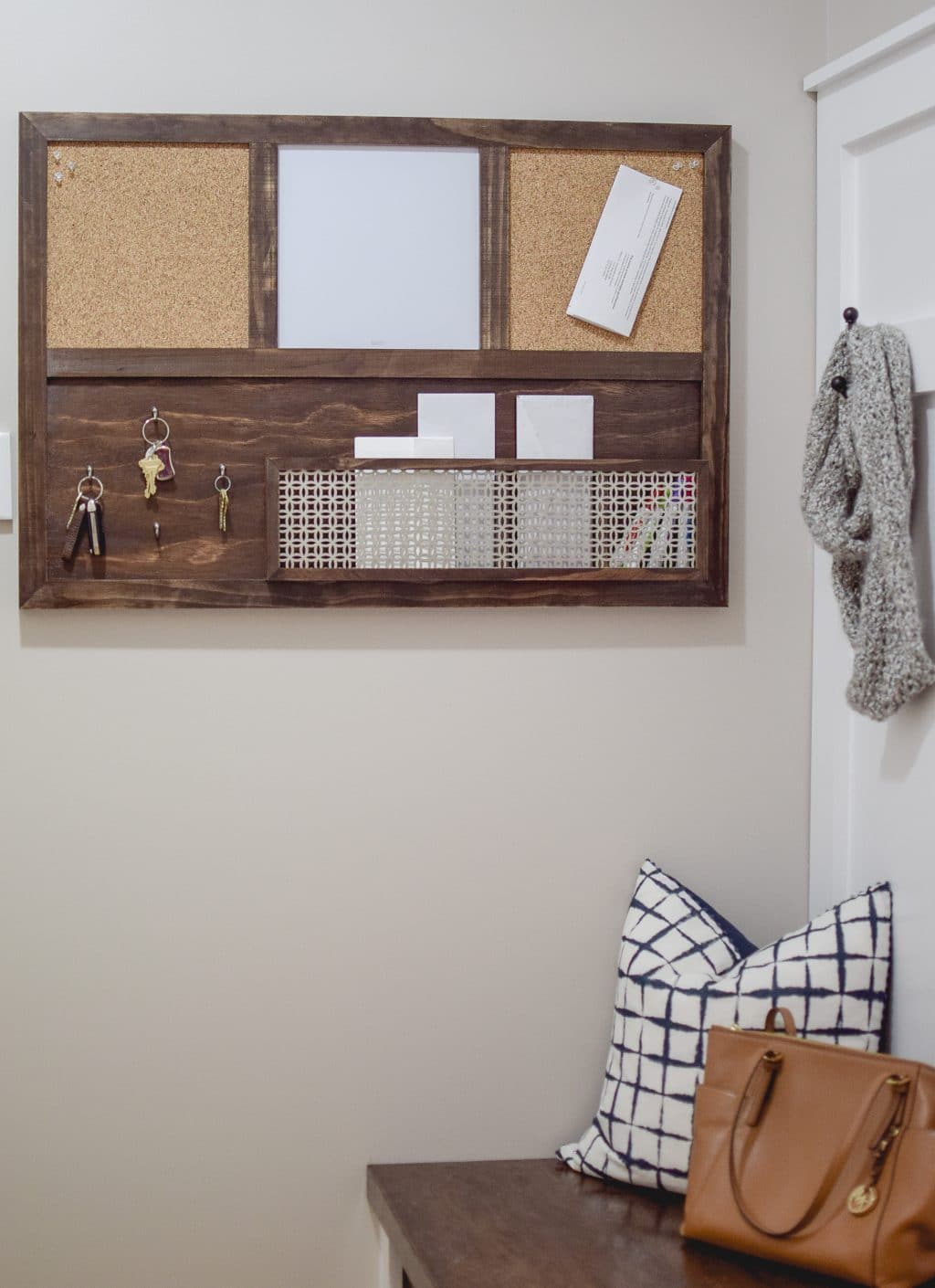 a family command center has hooks for keys, baskets to keep mail, and white boards for important notes