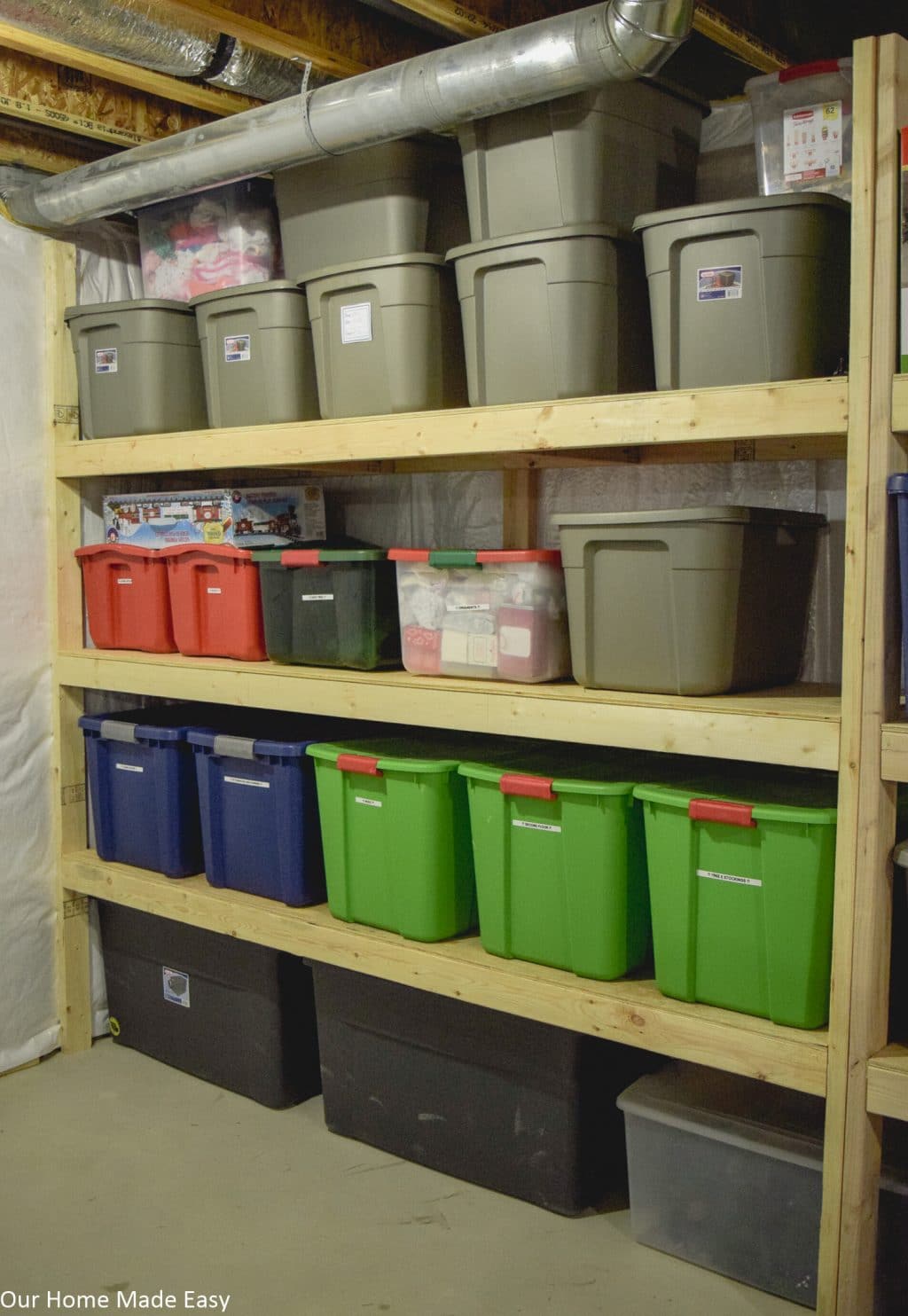 Shelves of Holiday decor storage bins in the basement