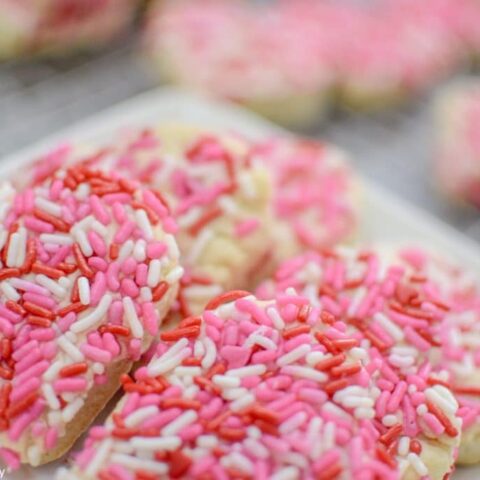 Super easy Valentine's Day cookies. They are soft and chewy and full of sprinkles! Click to see the sugar cookie recipe.