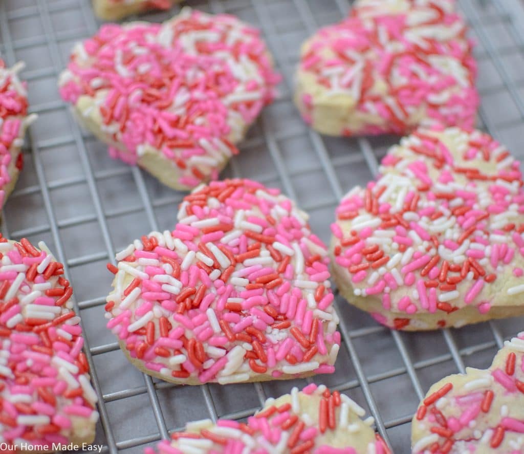 Super easy Valentine's Day cookies. They are soft and chewy and full of sprinkles! Click to see the sugar cookie recipe.