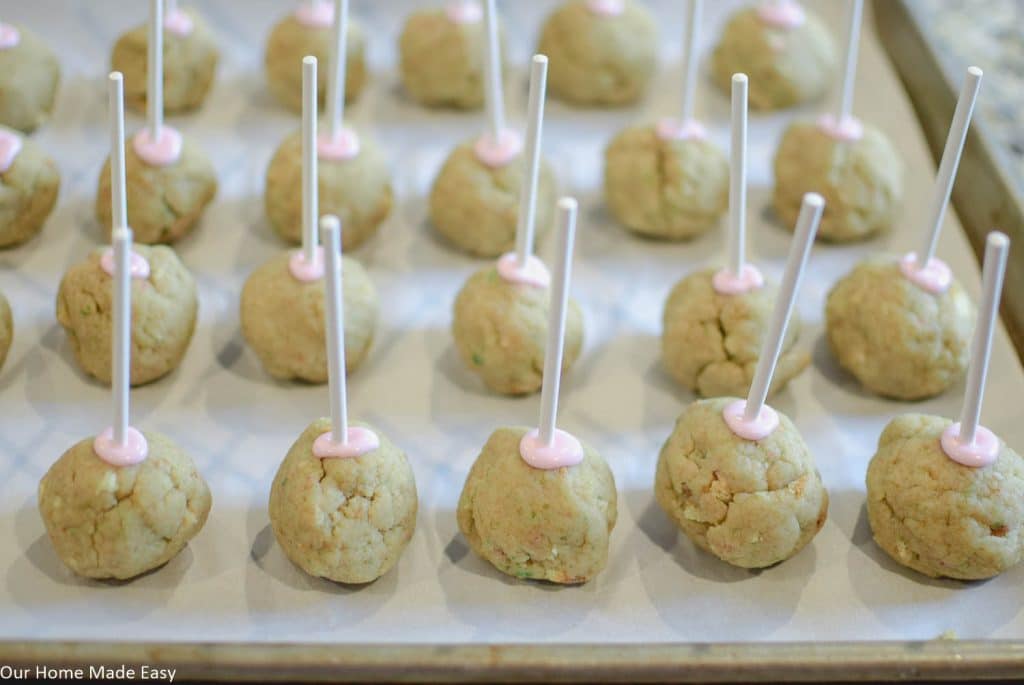 Before coating your cake pops, pop them in the freezer for a little bit to solidify. 