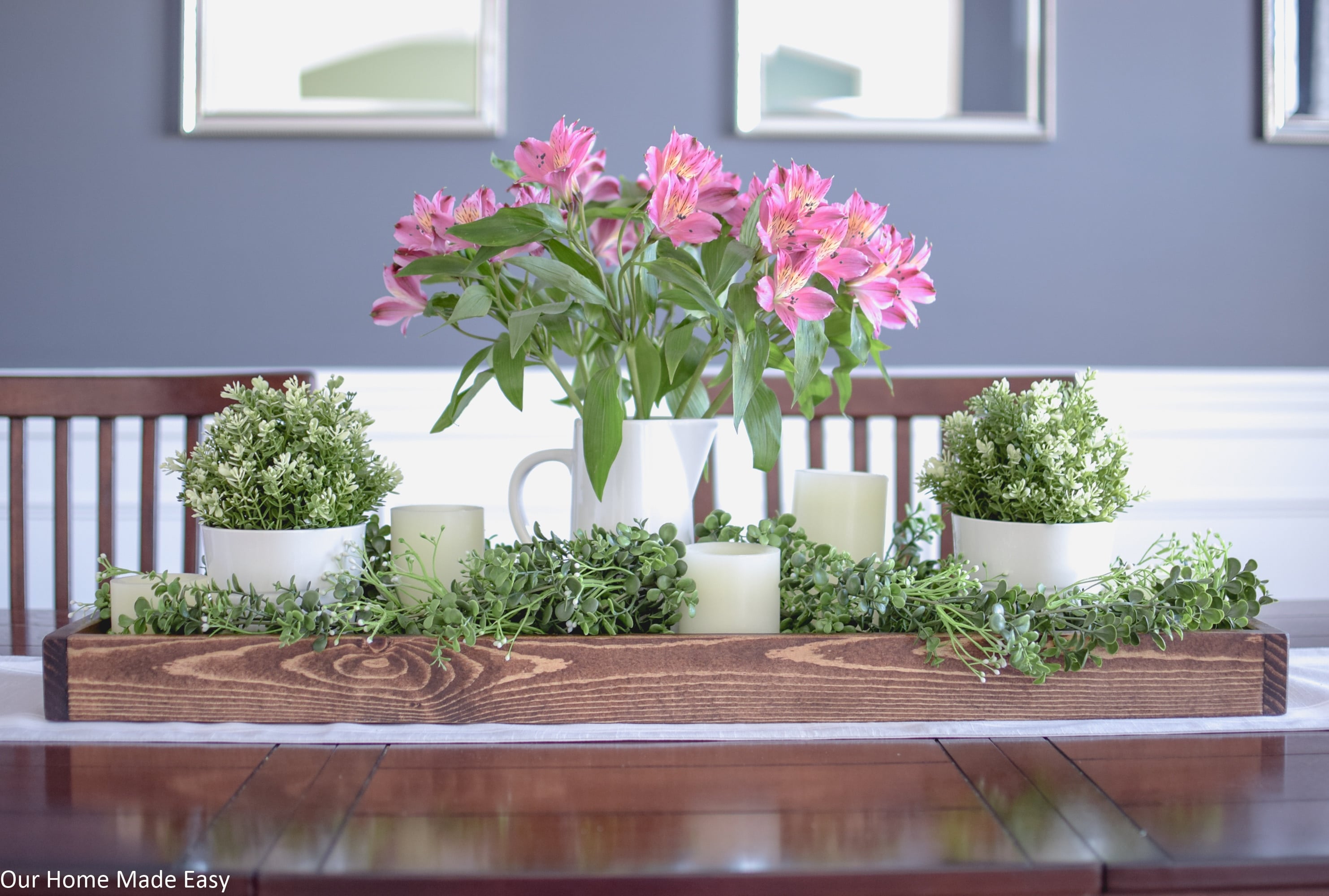 This bright and colorful Spring centerpiece is has faux flowers an greenery for a long-lasting and fresh look