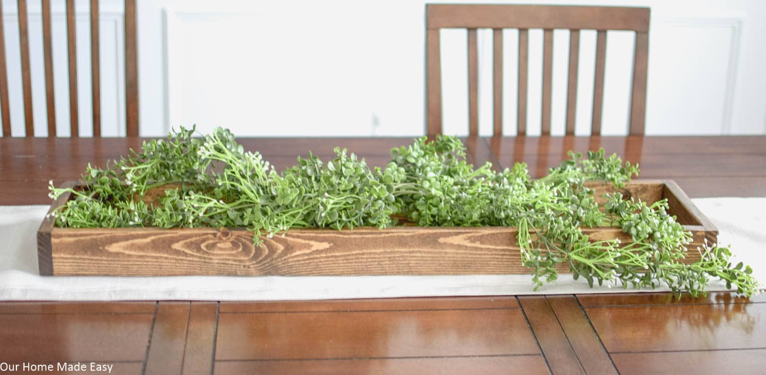 Lay down a base of faux greenery like these simple vines for your Spring centerpiece