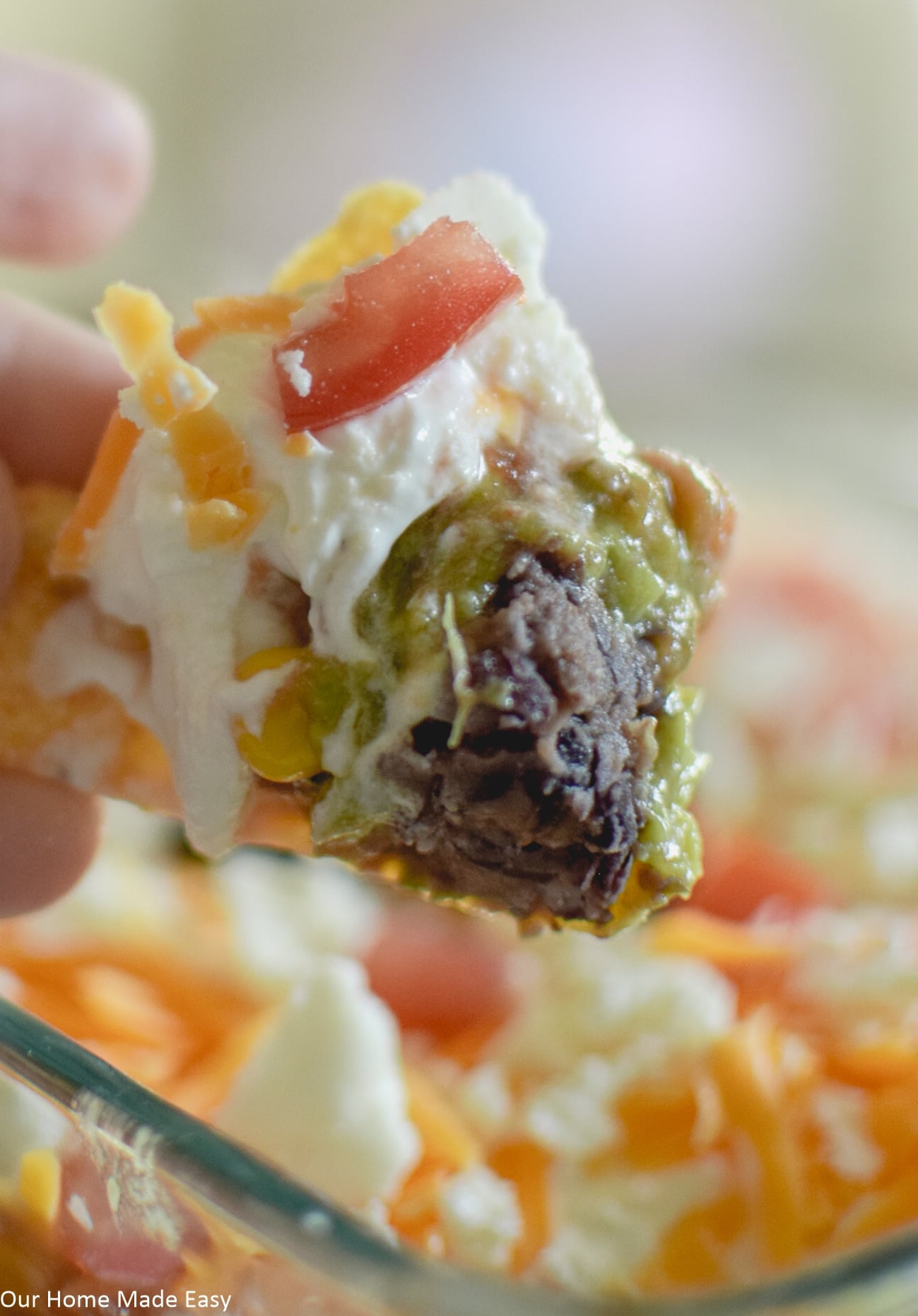 a perfect scoop of 7 layer taco dip