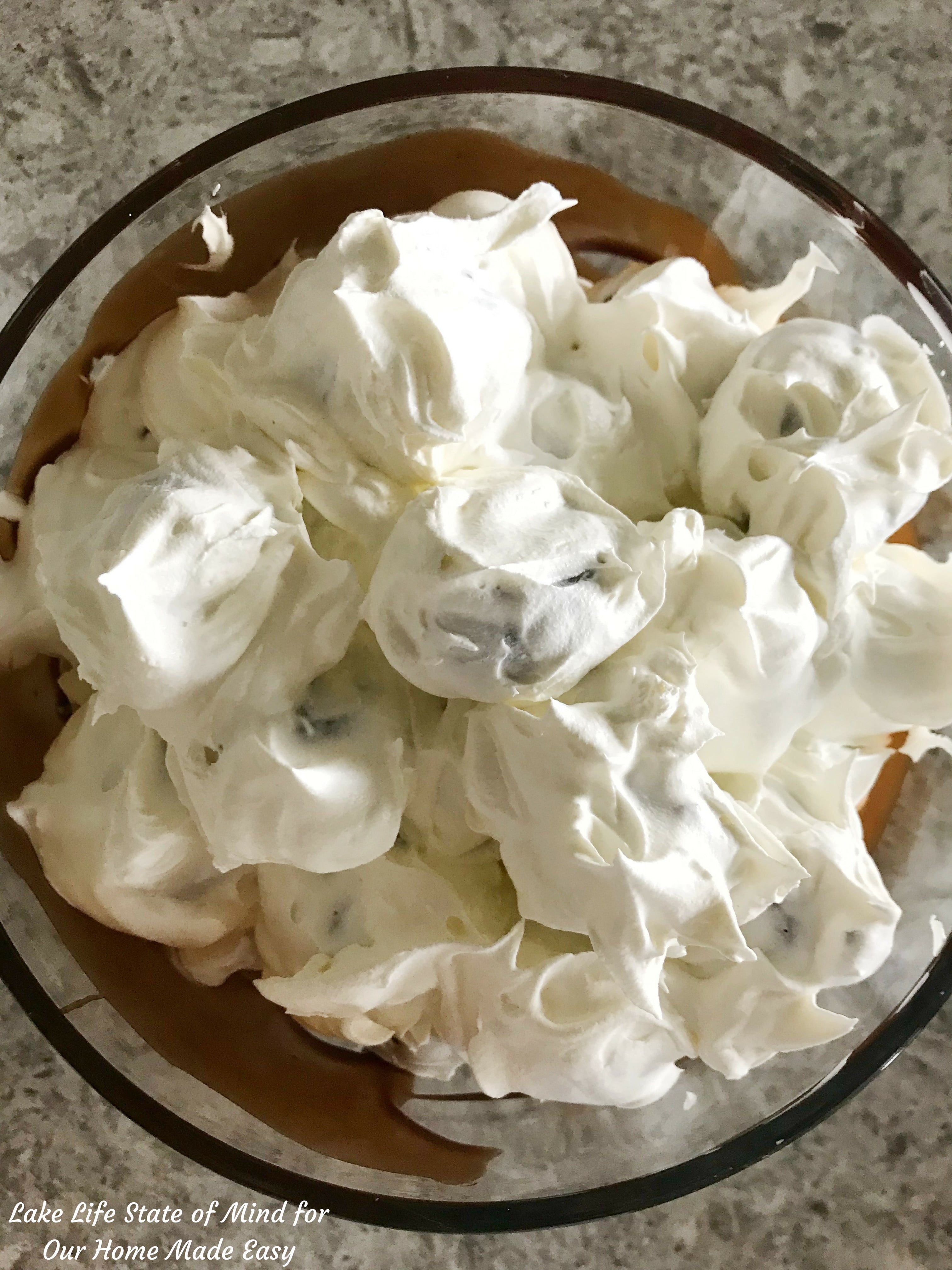 Cover the sweet cream puffs with whipped topping and layer into the chocolate syrup bowl
