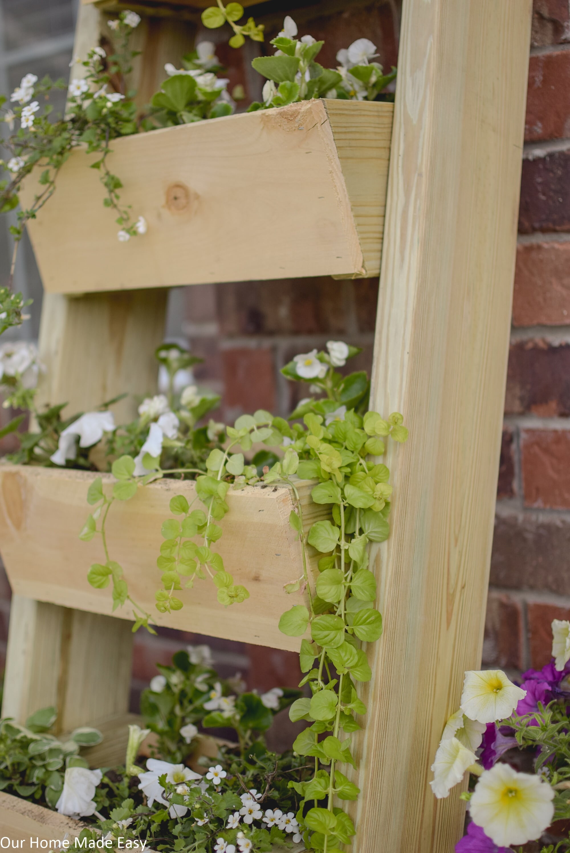 The baskets on my cedar ladder planter are lined with landscaping liner to help keep the soil and plants inside the baskets