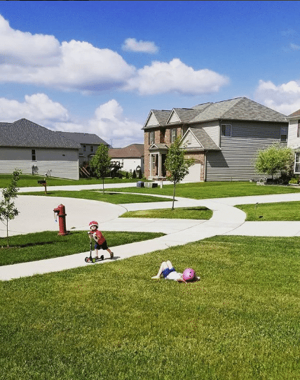 The kids are enjoying this beautiful day, playing outside on the lawn