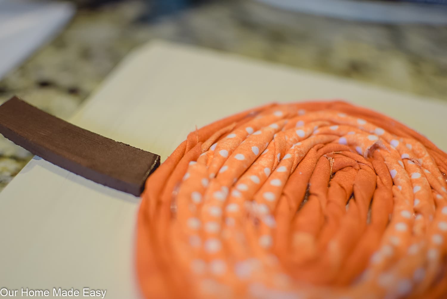 Twist the fabric around and around, making a fabric pumpkin shape