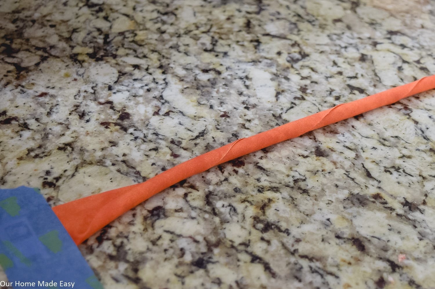 Roll the fabric into a rope-like cord to create the fabric pumpkin shape