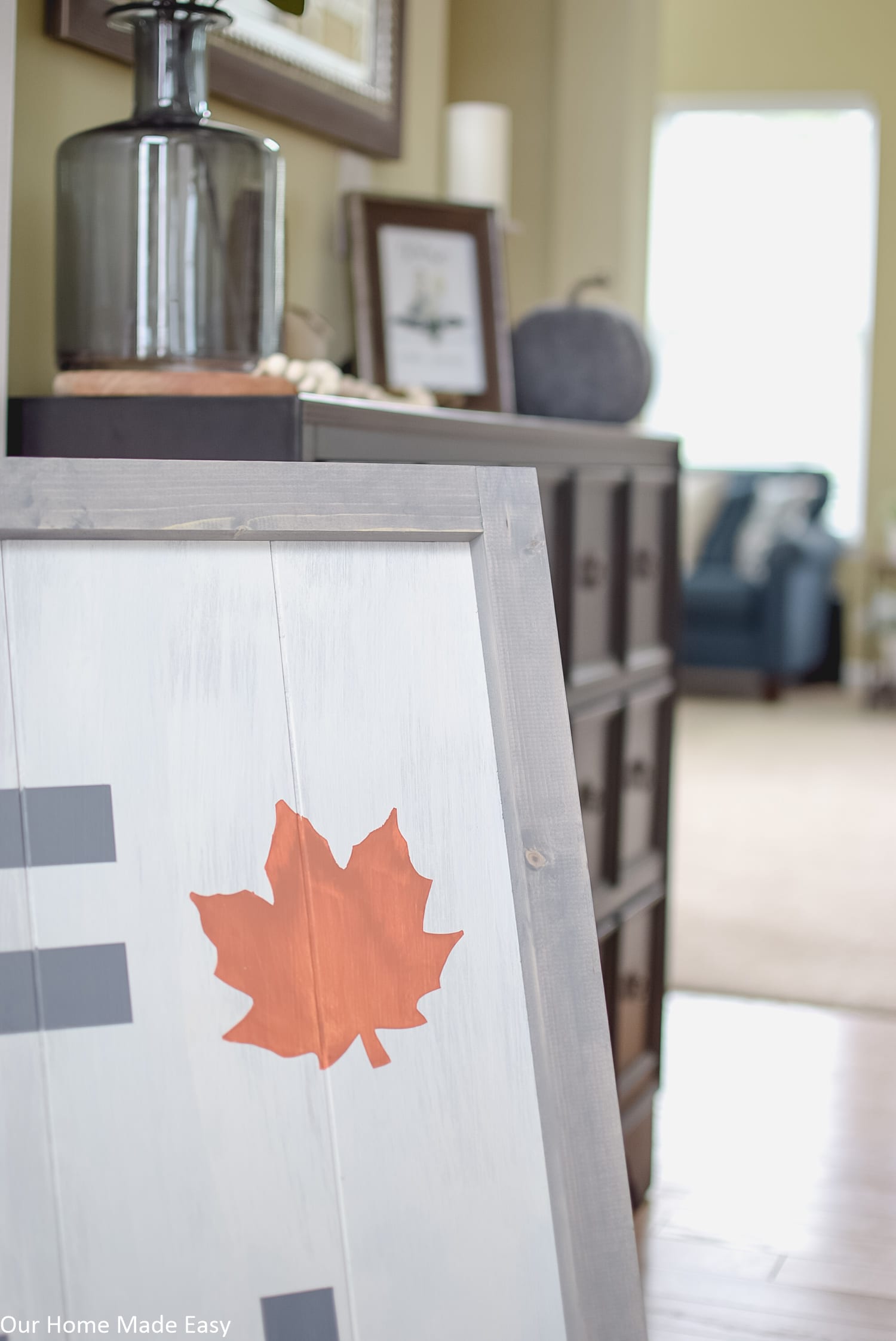 This wood Fall sign has a whitewashed blue gray frame and hand painted letters