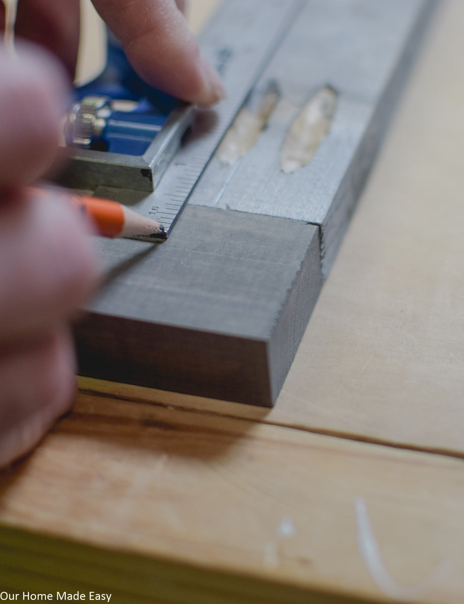 Using a ruler to measure out pocket screw holes and were to drill in the sign backboard