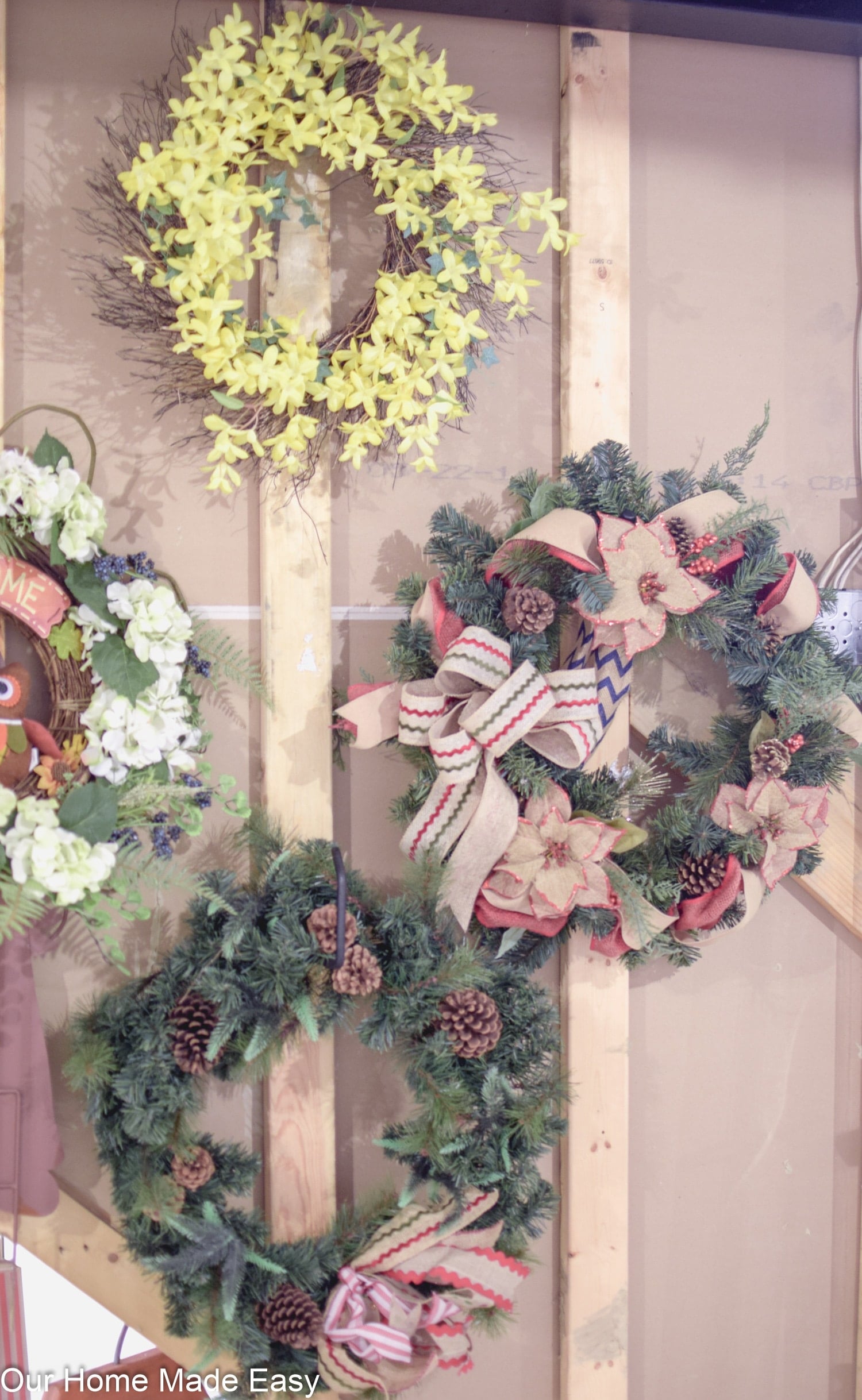 organize holiday wreaths with hooks to keep them pretty throughout the year