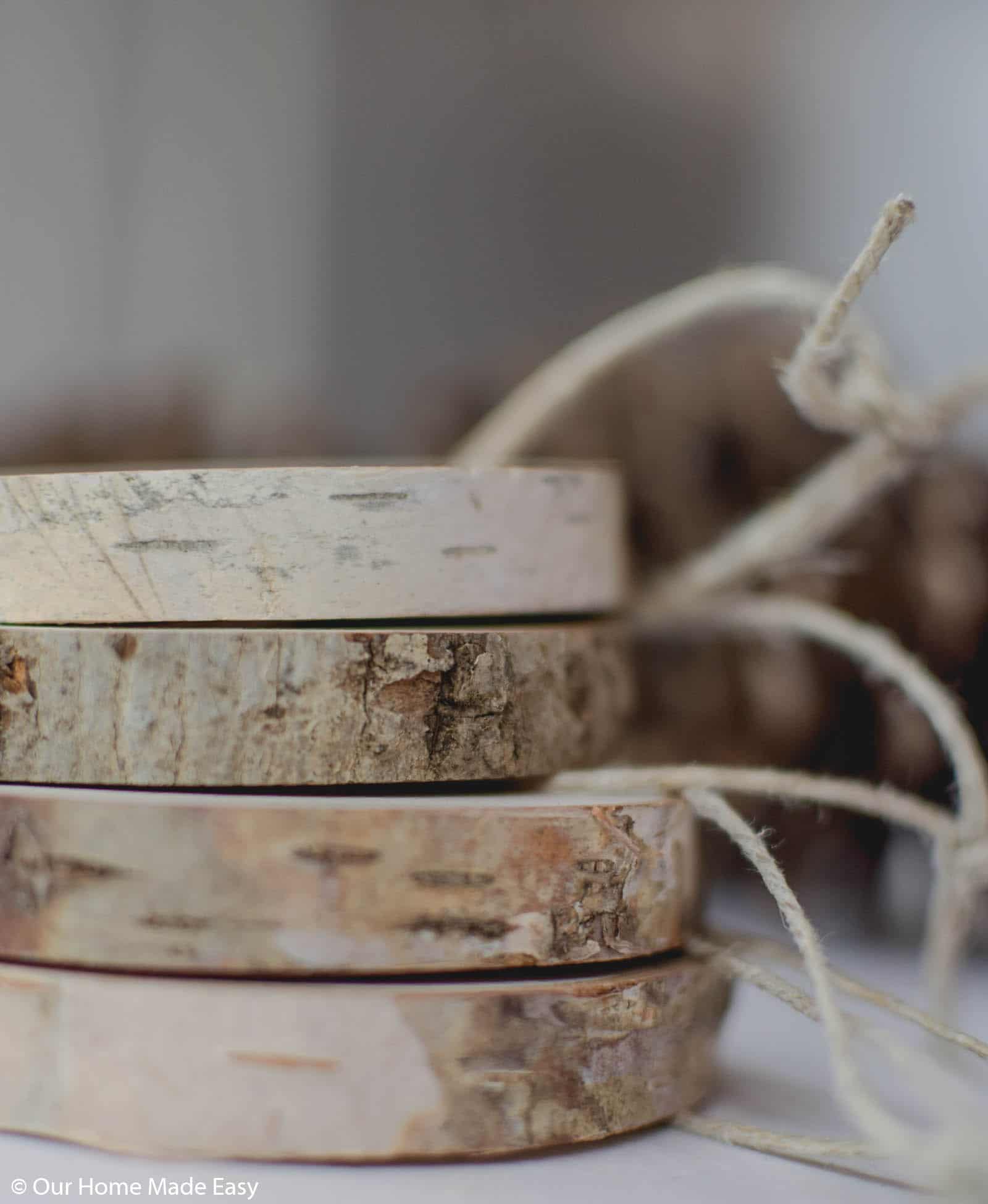 Tie twine around the wood slices to make these rustic wood slice ornaments easy to hang on your tree