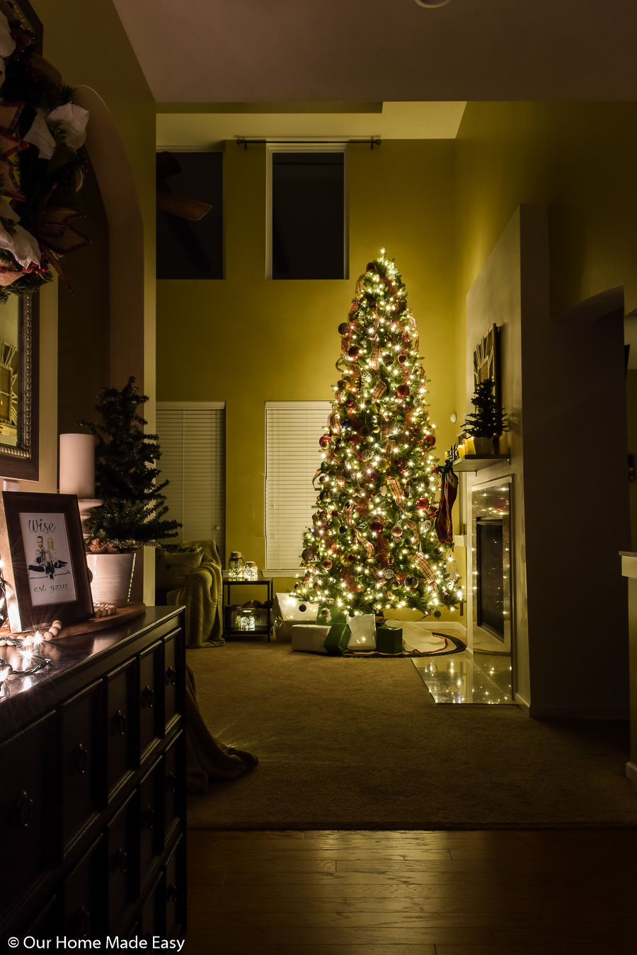 Our home's entry way has subtle Christmas decor, leaving the focus on the bright Christmas tree in the living room