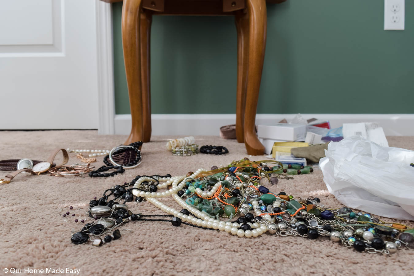 Sorting through an unorganized jewelry collection to decide which pieces to keep and which to donate