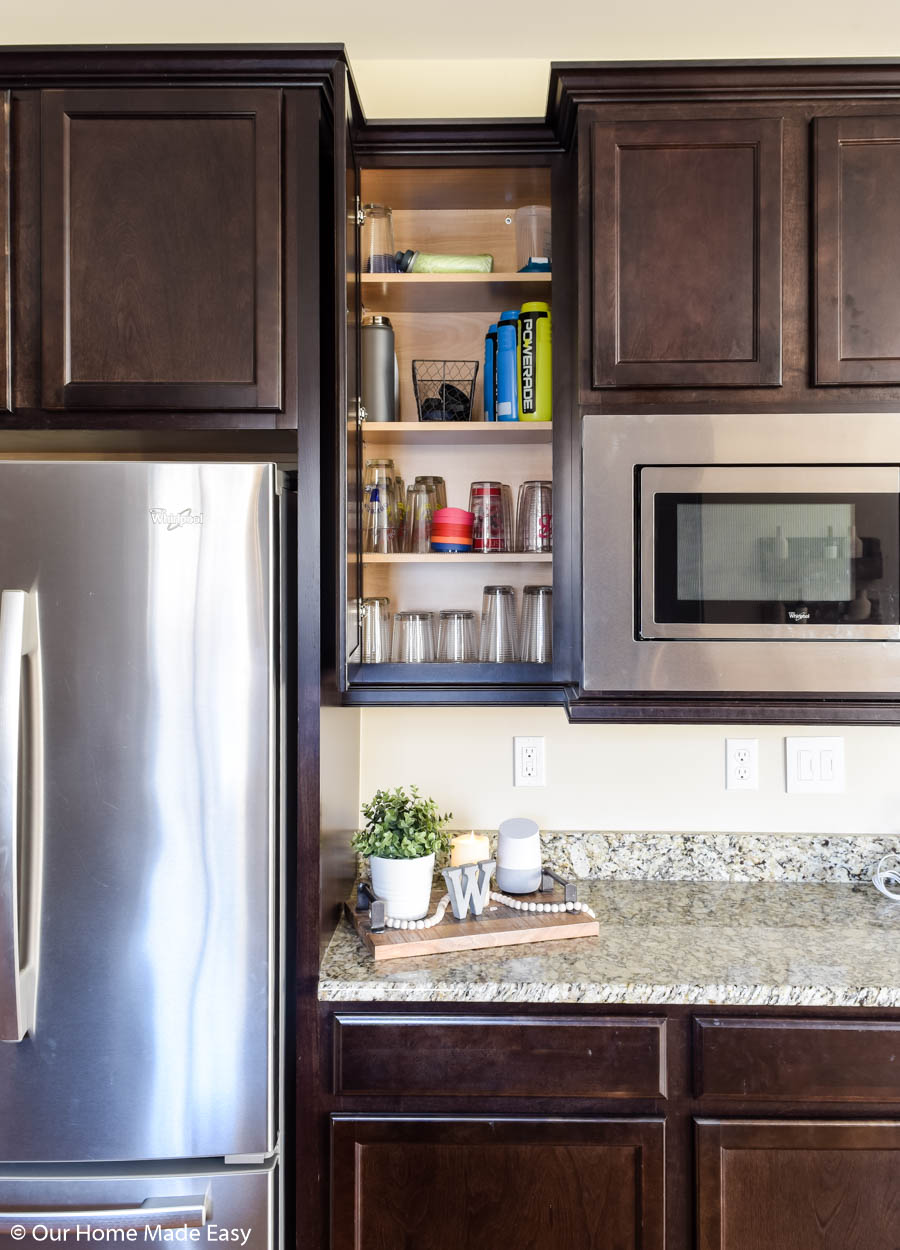 store the drinking glasses by the fridge for easy and convenient access