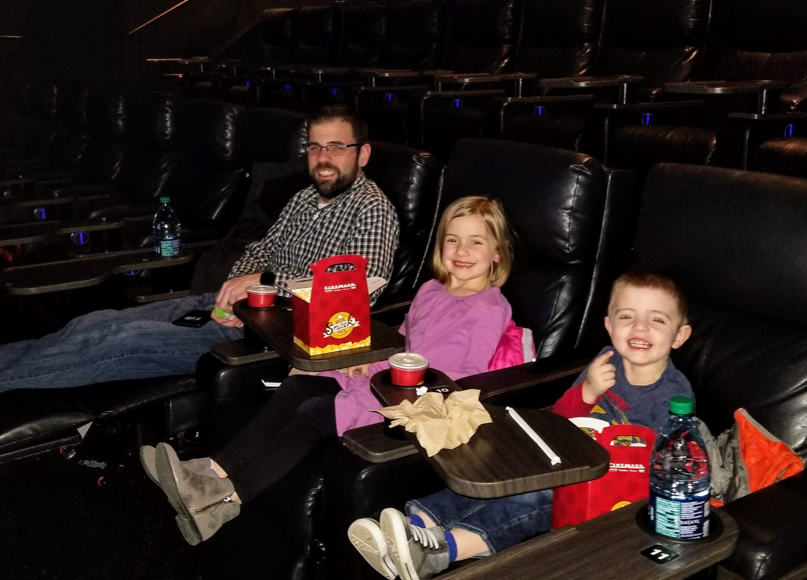 The family at a late night movie showing in an empty theater