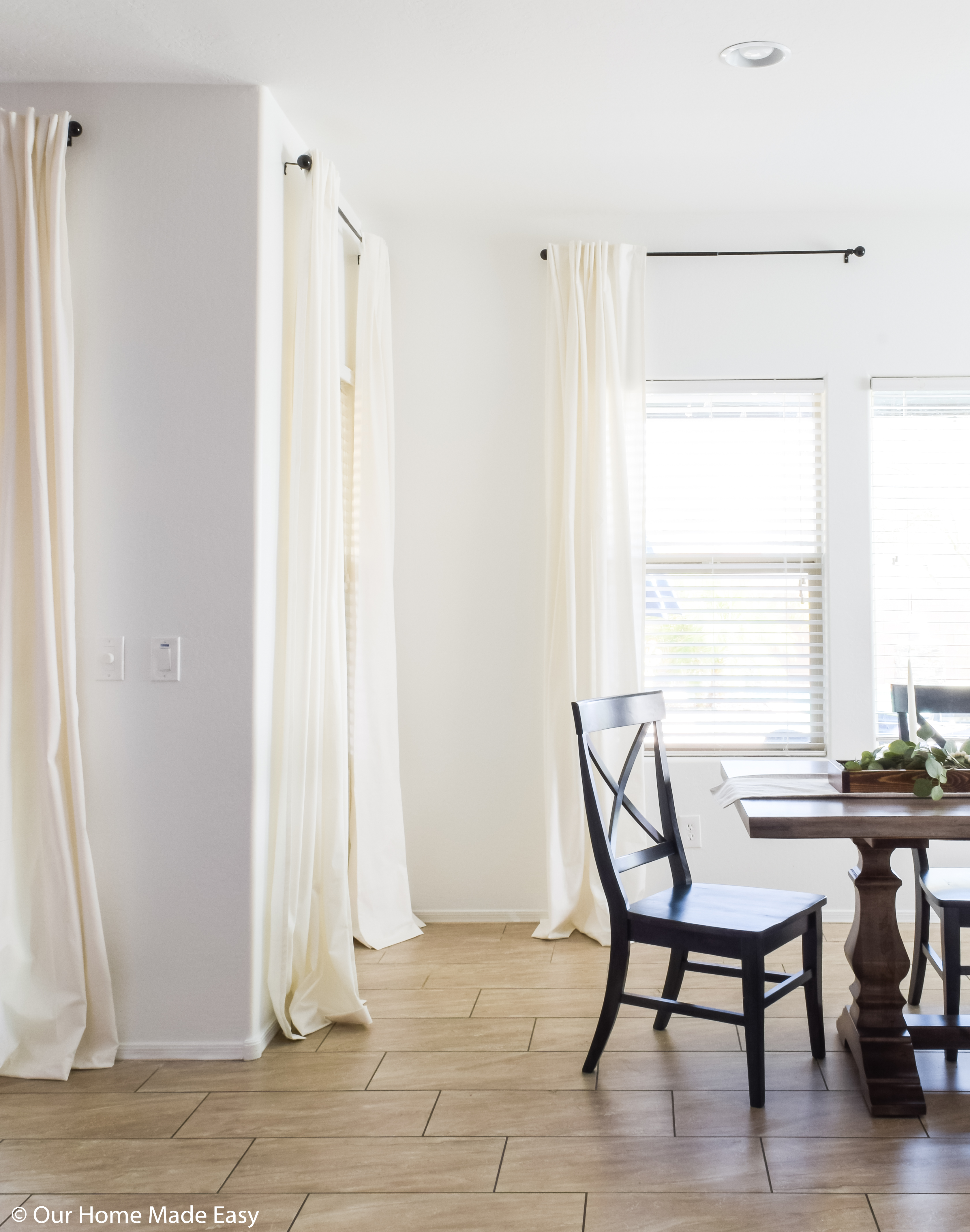 After making and hanging our DIY curtains, our living room looks bright and so much bigger!