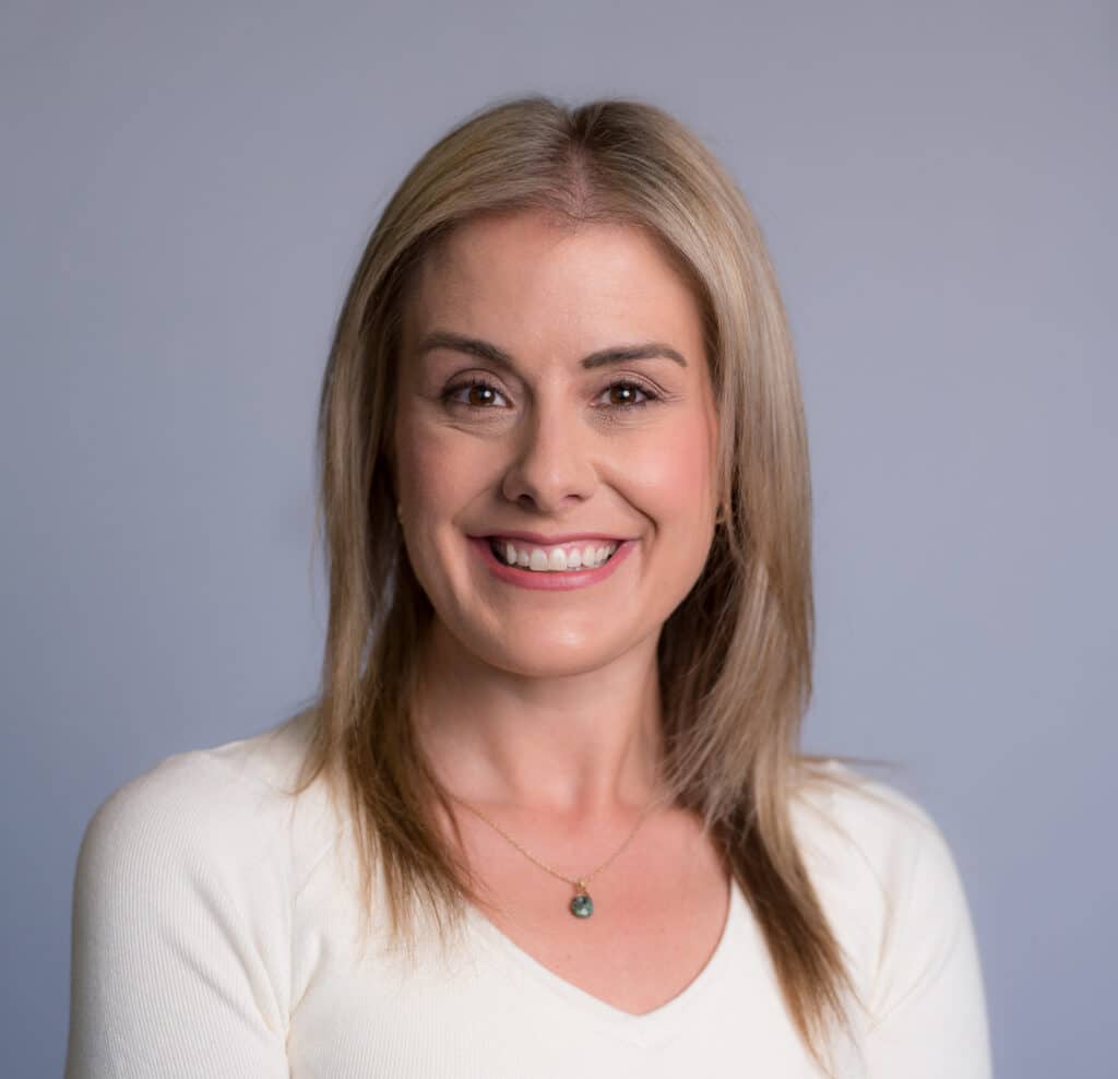 Brittany Wise in a Cream Sweater Headshot