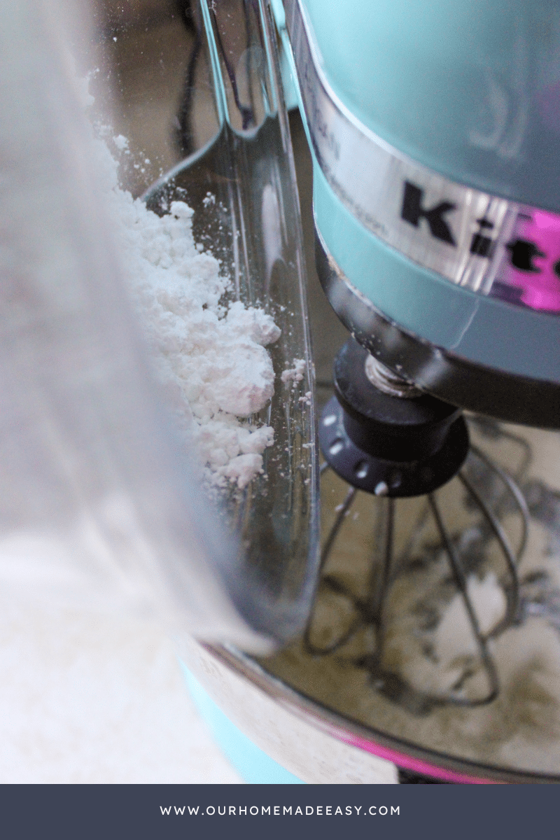 Pouring powdered sugar into mixer for brownie frosting