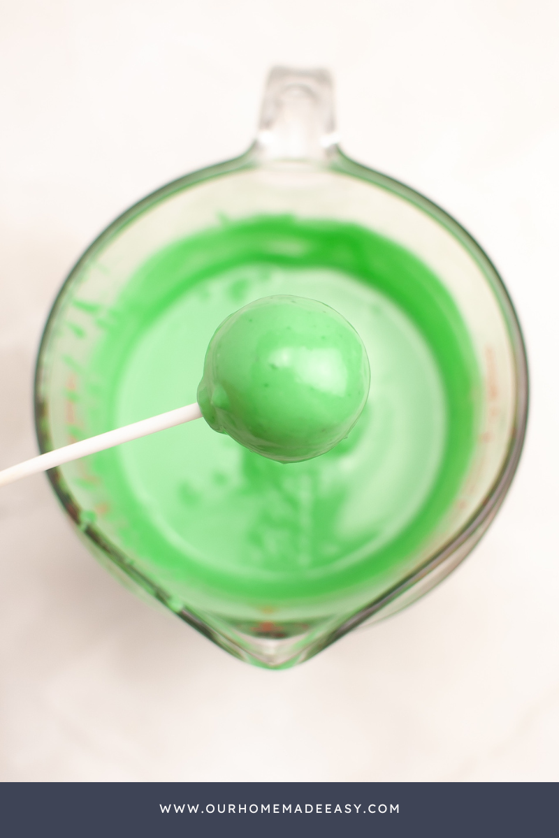 Grinch Cake Pops Being Dipped